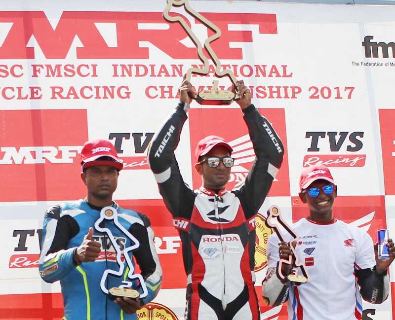 Mathana Kumar (centre), winner of Super Sport Indian  (up to 165cc) racef lanked by second-place.JPG