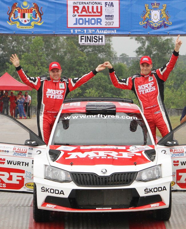 Ole Christian Veiby (right) and co-driver Stig Rune Skjarmoen celebrate victory in the Internati.JPG