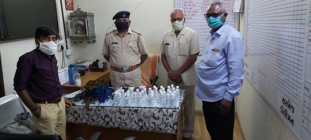 TML distributing masks and sanitisers to police men.jpg