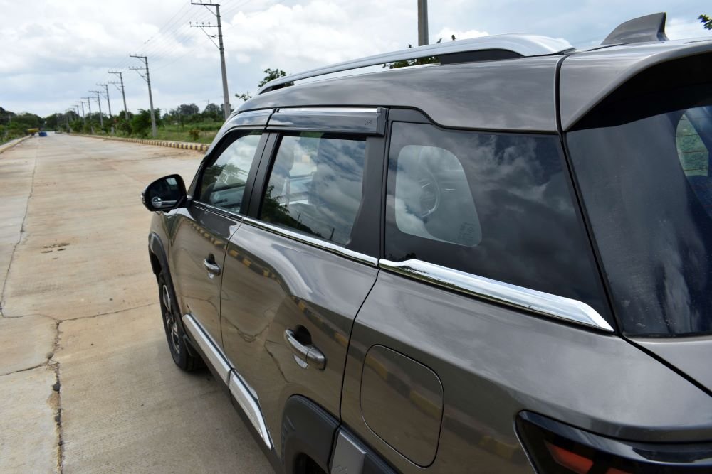 13. Glass area with door visor and chrome strip across the doors.JPG